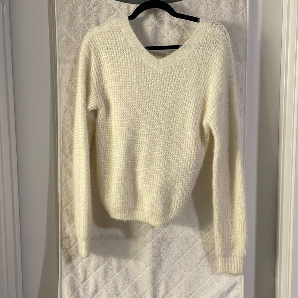 Cream knit sweater with knit detail in the back.